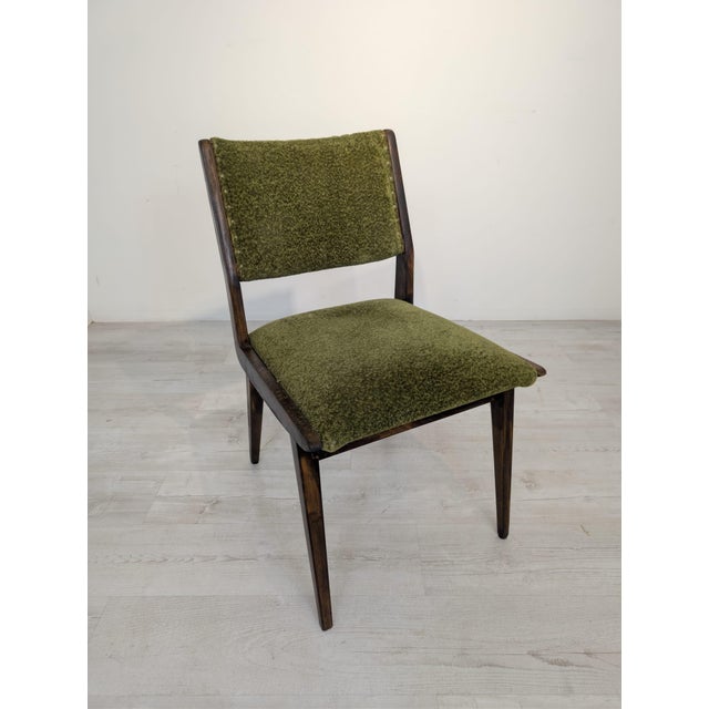 A "skopa" chair from the communist era in a mid-century style A vintage chair from the communist era, upholstered in a...