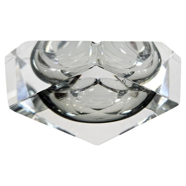 A striking Mid-Century Modern Murano ashtray bowl featuring the iconic Sommerso technique, with faceted grey glass...