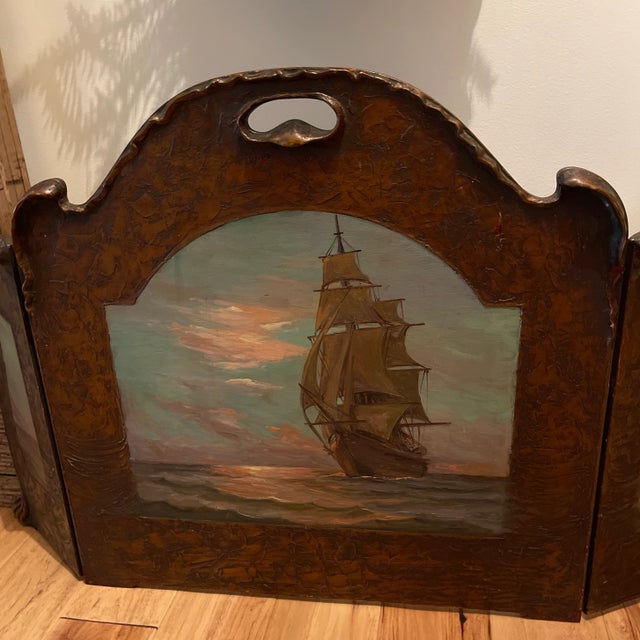 Triptych Arts & Crafts style folding firescreen with an original painting of a clipper ship on the water. Arched form with...