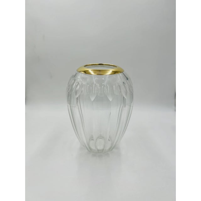 A Tiffany & Company gold over sterling silver banded crystal vase. The vase made of German cut crystal with faceting to...