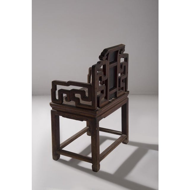This low Qing-style chair, probably identifiable as a "Rosa" chair, is a fine example of Chinese craftsmanship, made in...