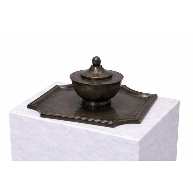 This refined desk accessory features a beautifully proportioned, rounded ink pot with a domed lid and finial, set upon a...