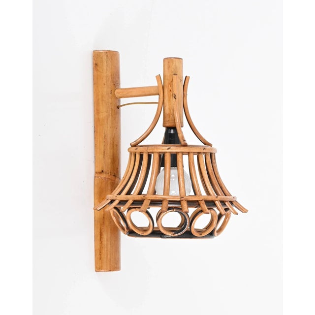 Stunning wall lamp in rattan and bamboo produced in the 1960s in france and attributed to louis sognot. This rare and...