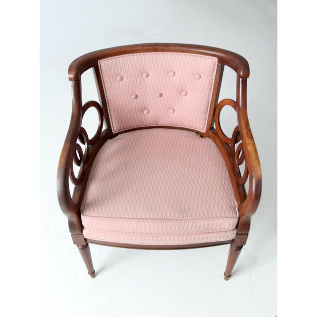 This early 20th century Classical Revival armchair reflects timeless craftsmanship with a softly curved wood frame and...