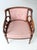 This early 20th century Classical Revival armchair reflects timeless craftsmanship with a softly curved wood frame and...
