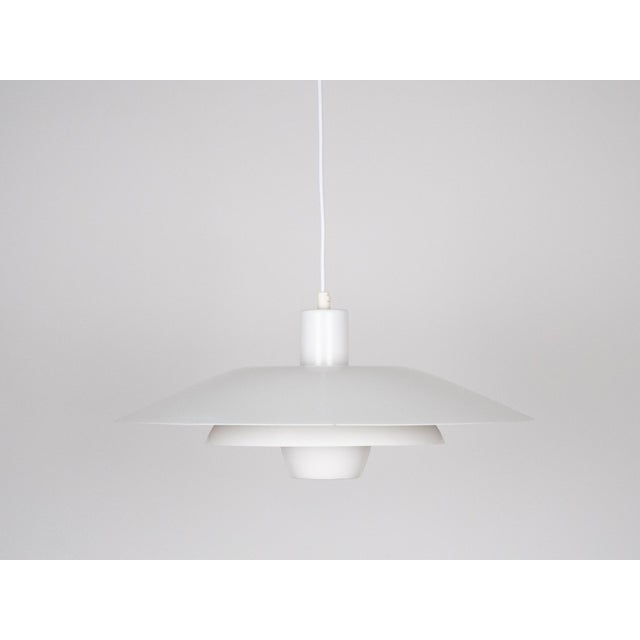 This lamp was designed by Danish designer Kurt Wiborg and manufactured by Jeka. The lamp's form is based on the principle...