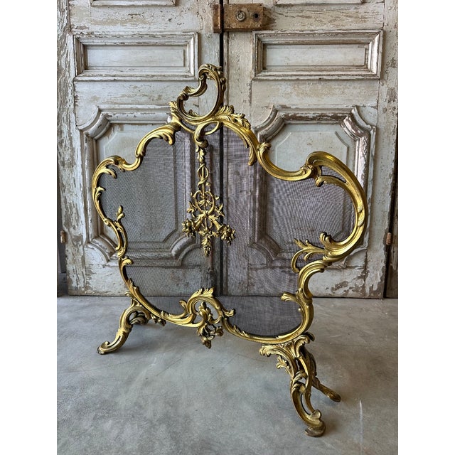 Gilt bronze fire screen, 19th century. Ornamental central section, openwork feet. Good condition, gilt finish. H 77 x W 74...
