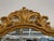 A fine pair of Italian gilt wood wall or console mirrors. Each having a clean center mirror flanked in a carved pierced...