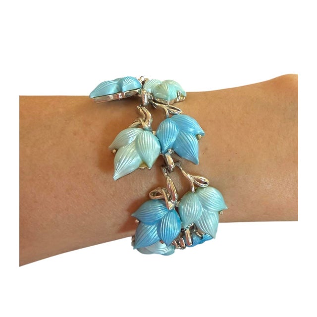 Vintage Lisner blue thermoset bracelet with safety chain. Blue and light teal leaves are gorgeous.