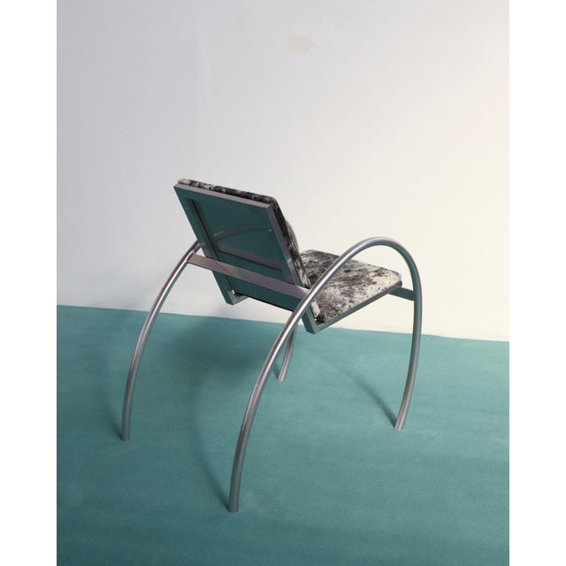 1980s armchair attributed to Alain Domingo & François Scali for Nemo, with hair-on cowhide upholstery and a powder-coated...