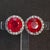 Here is a pair of 14k White Gold Stud Earrings with Two ~5.0ct. Round Lab Ruby Center Stones & Multiple ~0.4ct. G/I1 White...