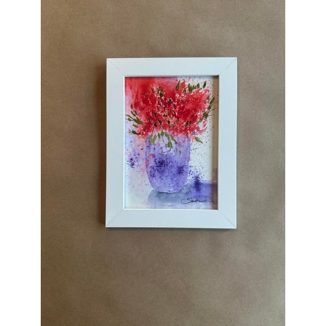 A vibrant, expressive watercolor bursting with energy. Bold crimson florals explode outward from a softly blended lavender...