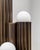 Vesta table lamp by schwung dimensions: ø 15 x h 61 cm materials: triplex opax transparent glass, lacquered burnished...