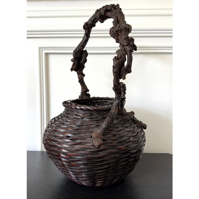 Large and robust in presence, this antique Japanese bamboo flower basket (ikebana) with tall handle is dated to the late...