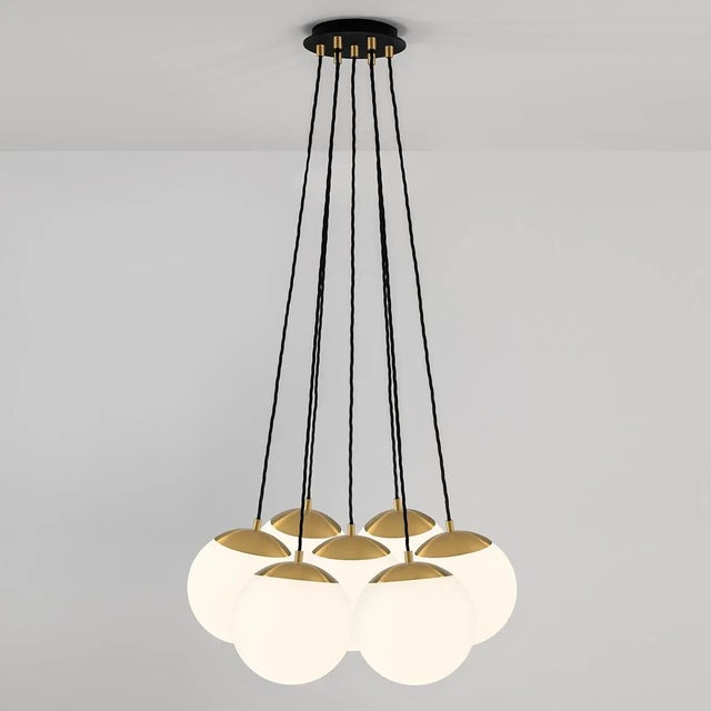 Seven Suspended Globes Hang On Twisted Cable From A Narrow Point Within A Ceiling Plate Allowing All Globes To Touch And...