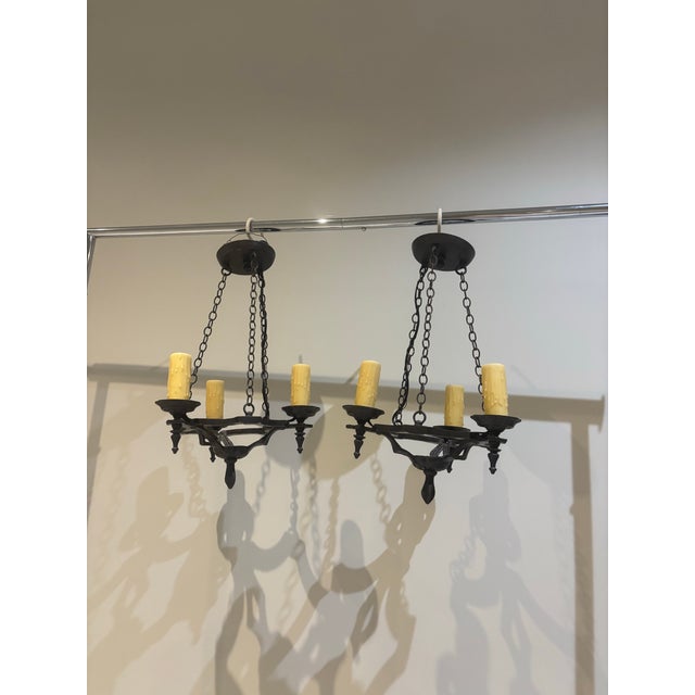 Simple yet elegant vintage cast bronze chandeliers with 3 ivory faux candlelights. Oil rubbed bronze finish.