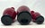 Donald Carlson Art Glass, Vase Trio American Artist A Trio of hand-blown cardinal red glass stick vases, each with applied...