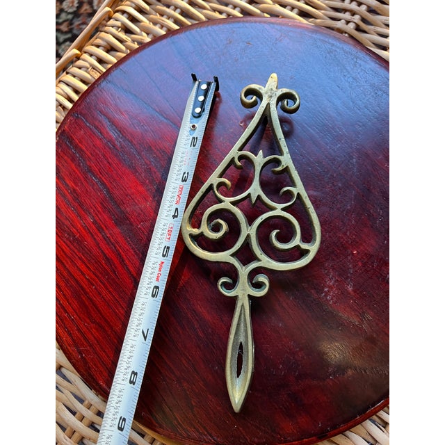 Up for consideration is a beautiful vintage small brass scrolling trivet. This would look lovely in your home and it is a...