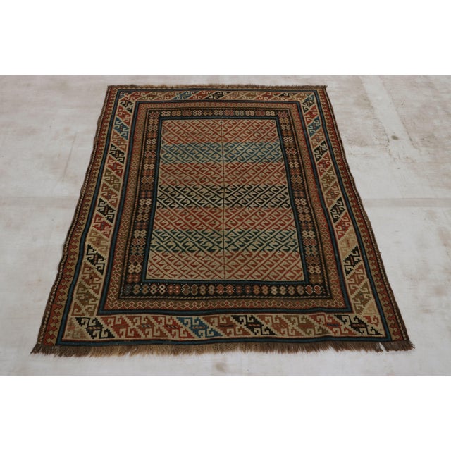Hand-knotted in wool and originating from Russia circa 1880-1890, this 4x5 antique rug of Kuba provenance is the latest...