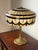This striking vintage Tiffany Revival table lamp pairs a large leaded stained glass shade with an especially appealing...