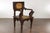 An Anglo-Indian carved wooden armchair from circa 1900 with carved back and mythical creatures on the arms. This...
