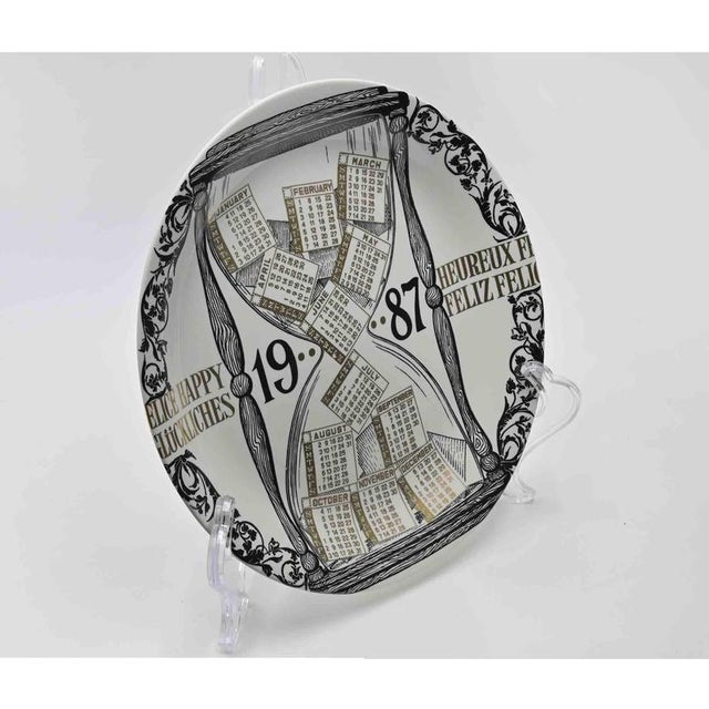 Happy 1987 - Calendario is a silk-screened porcelain plate, designed by Piero Fornasetti i n 1987 from the Calendario...