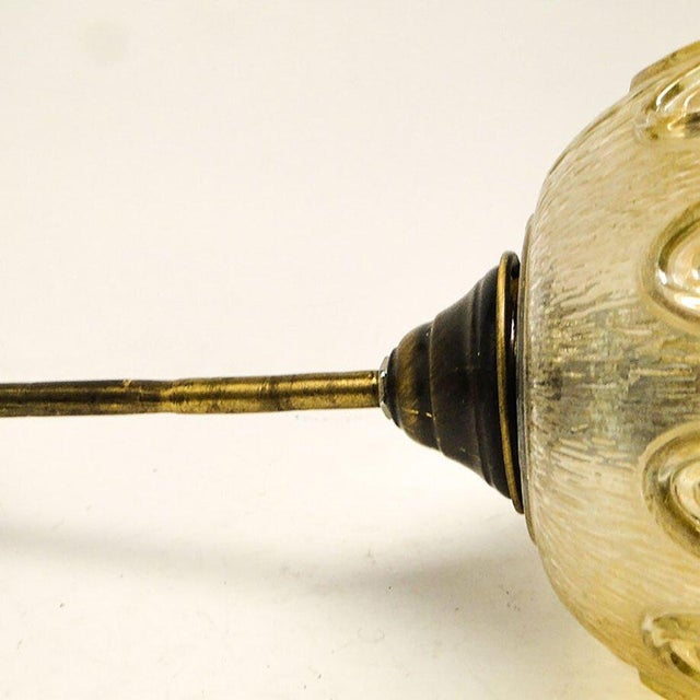 The pendant lamp was produced in the 70s. The construction is made of brass, in a shade of glass. It is maintained in very...