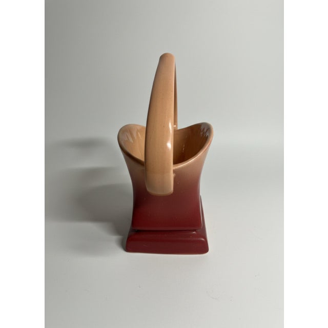 A beautiful vintage Roseville Pottery basket in the Snowberry pattern, introduced in 1947. This sculptural example is...