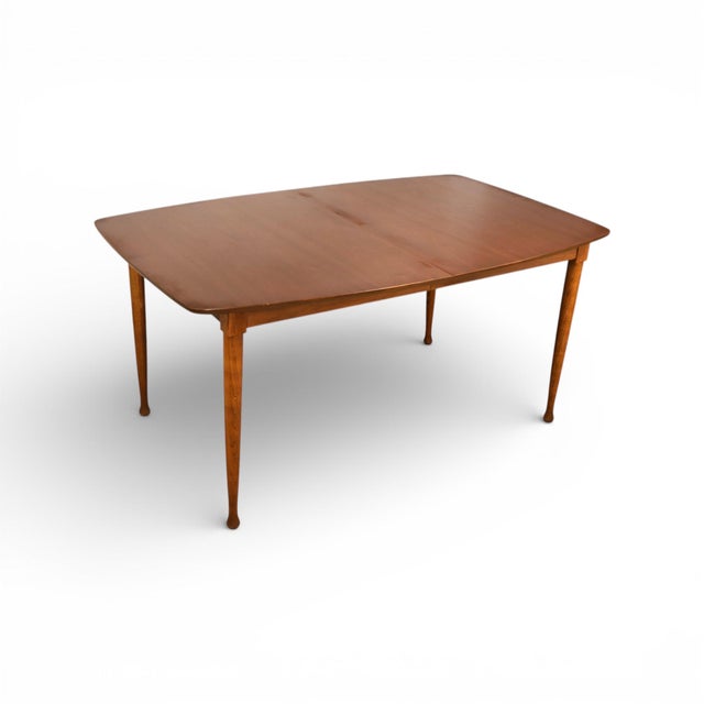 This vintage mid century modern dining table by United Furniture dates to the 1960s and features a clean, architectural...