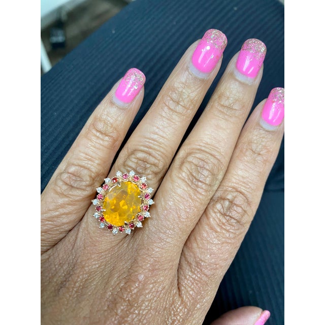 3.83 Carat Oval Cut Fire Opal Sapphire Diamond Yellow Gold Cocktail Ring This ring has a 3.32 Carat Oval Cut Orange Fire...