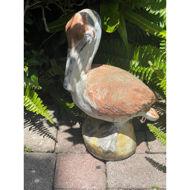 Beautiful vintage concrete multicolor pelican garden sculpture.