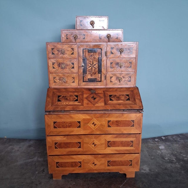 An exceptional antique writing desk with intricate marquetry and impressive interior design. The upper section is an...