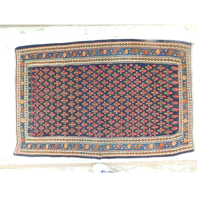 Add a touch of elegance to any room with an antique handmade flatwoven kilim rug. This beautiful rug features tribal...