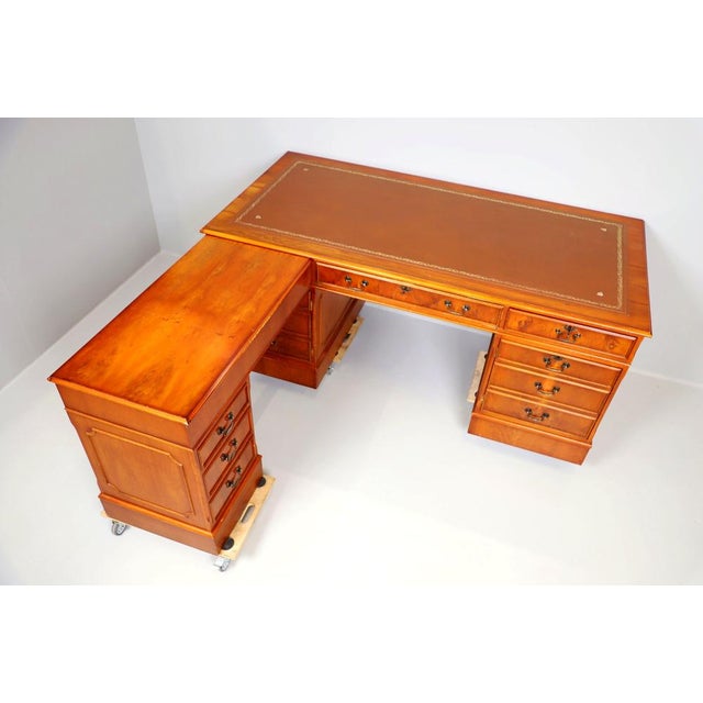 This sophisticated l-shaped executive desk, crafted in the georgian revival style, offers elegance and functionality for a...