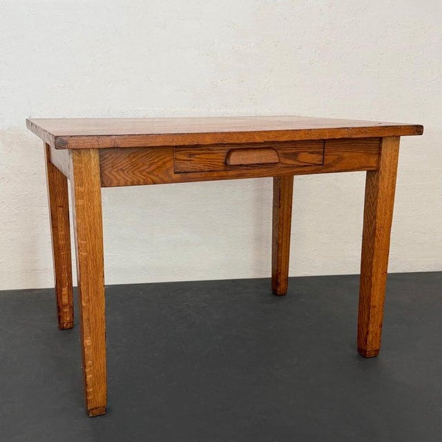 This early 20th century, quarter sawn oak desk manufactured by The Gunn Furniture Company is a a flexible industrial piece...