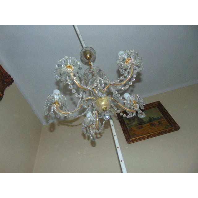 This chandelier features glass crystals. It has six sockets and requires E14 bulbs. European Plug (up to 250V).The wiring...