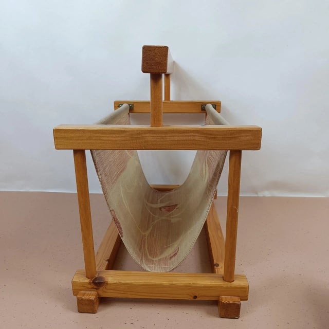 Cool wooden Magazine Rack from the 70s made of spruce wood with a gracefully decorated cotton cloth inside. The item fits...