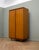 A 1960s British teak wardrobe by Butilux. The fitted interior includes hanging space, glazed storage compartments, two...