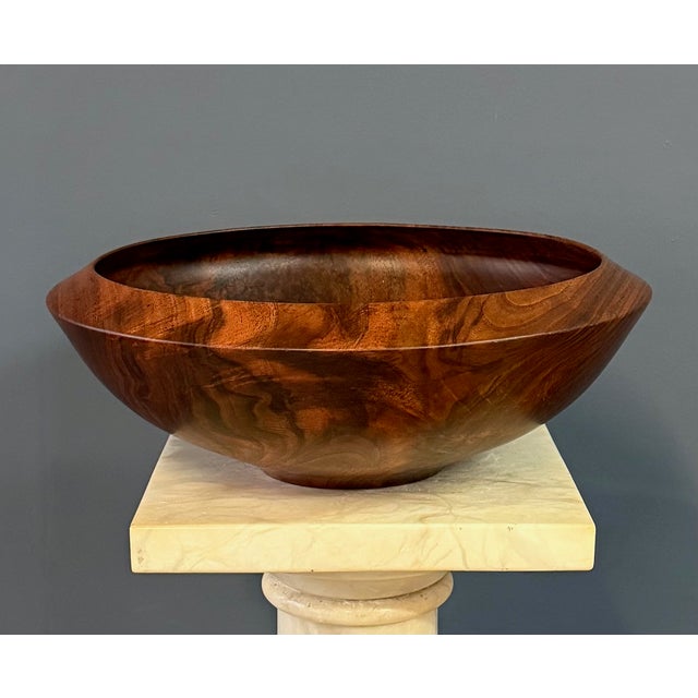 A beautifully hand-turned claro walnut bowl by American wood artist Bruce Mitchell, dated 1981. This sculptural vessel...