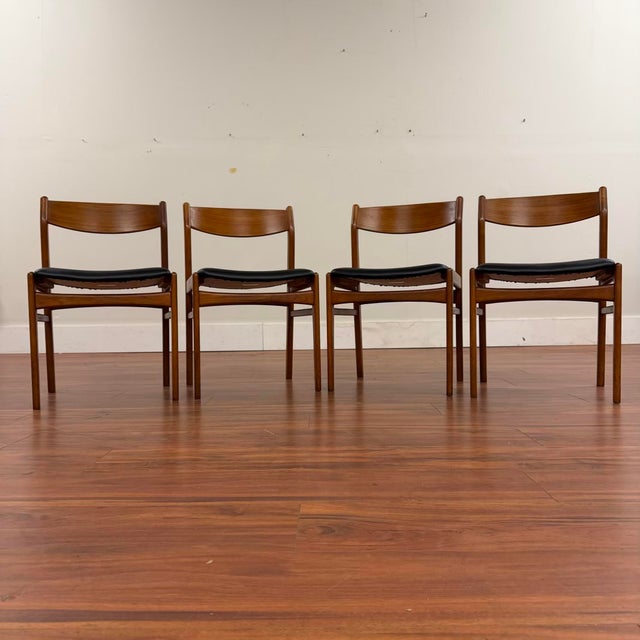 Set of four vintage teak low back dining chairs made in Denmark by Hong Stolefabrik circa 1960's. These chairs feature...