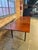 A stunning mid-century modern dining table designed by George Nelson for Herman Miller, featuring a richly figured...