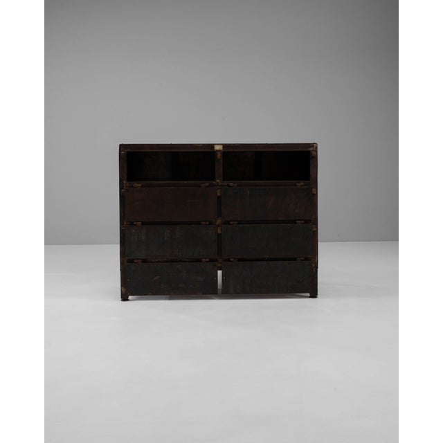 This striking 20th Century French iron chest of drawers embodies a rugged industrial aesthetic, perfect for contemporary...