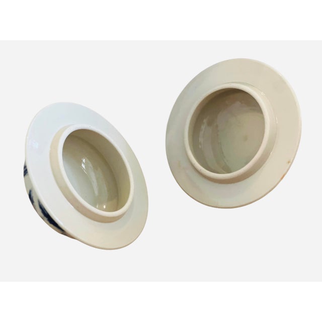 Lidded Ginger Jars featuring a traditional Chinoiserie landscape. Pretty blue/white motifs in excellent condition. Bottom...