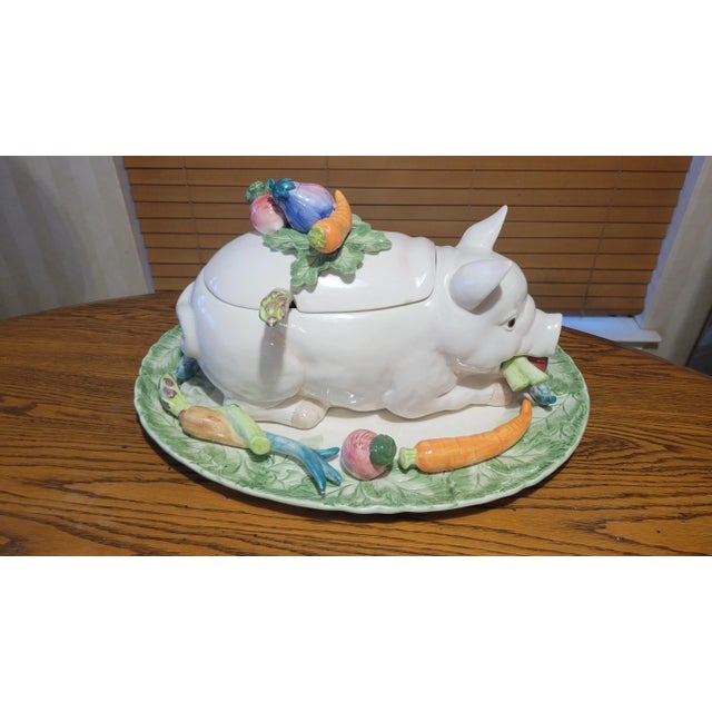 This delightful ceramic serving piece is a feast of whimsy and craftsmanship, designed in the form of a reclining pig...