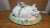 This delightful ceramic serving piece is a feast of whimsy and craftsmanship, designed in the form of a reclining pig...