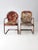 This is a pair of mid-century metal patio chairs. One chair features the classic "shell" back, and the other has a more...