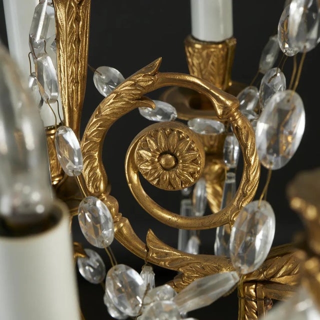Elegant French Louis XVI gilt bronze 12 light chandelier with crystal and glass beads and drops. Electrified in the early...