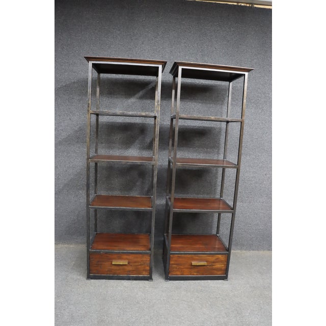 Exceptional pair of Acquisitions by Henredon étagère bookcases featuring a sophisticated blend of hand-finished iron...