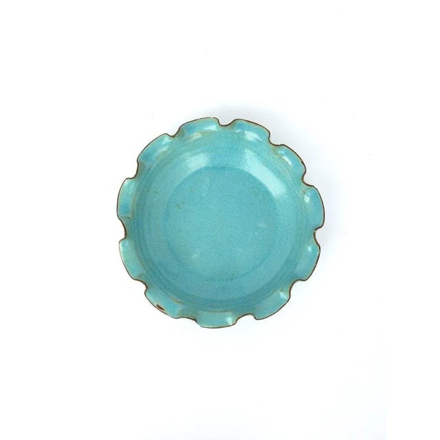 A beautiful sky-blue or turquoise blue pottery bowl with ruffled edge. Great as a standalone piece, as a catch-all, or...