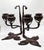 These are a pair of Tiffany Studios candlesticks. They are bronze with a Fleur-De-Lis motif base. They are stamped...
